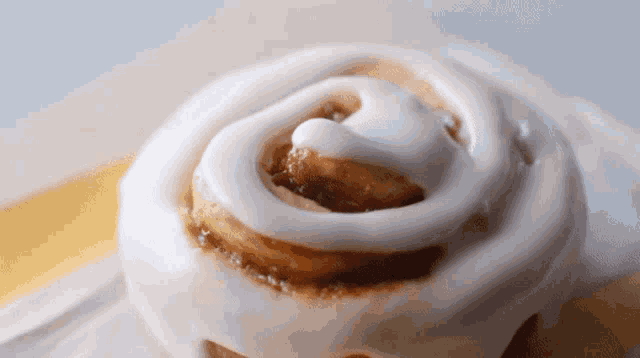 a close up of a cinnamon roll with icing