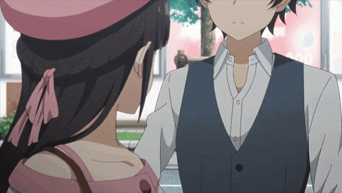 a girl in a pink hat looks at a boy in a suit