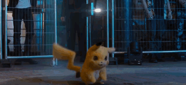 a pikachu standing in front of a fence with a flashlight
