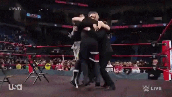 a group of people hugging each other in a wrestling ring with the word usa on the bottom
