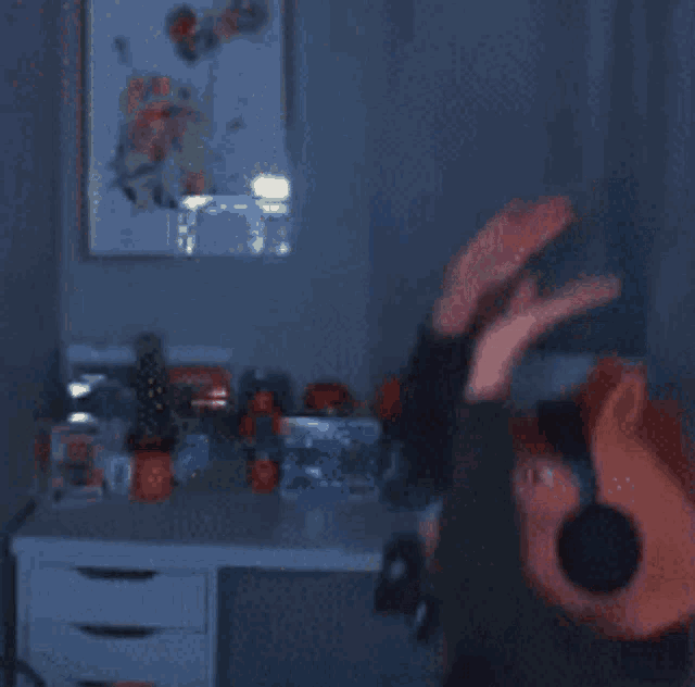 a blurred image of a person wearing headphones and a pig head