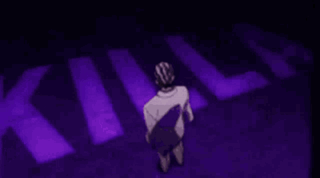 a man in a suit is standing in front of a purple light .