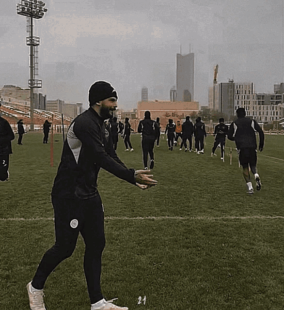 a group of soccer players are on a field with the number 24 on the ground