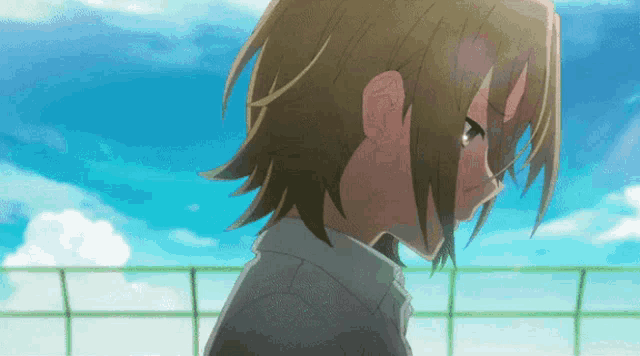 a close up of a person 's face against a blue sky