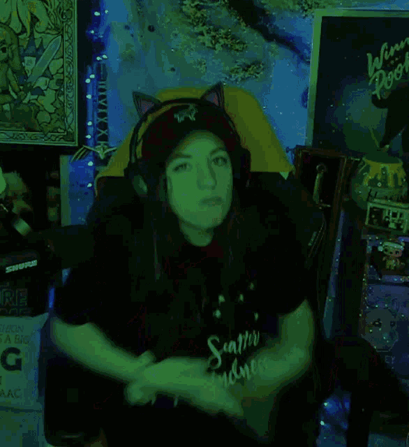 a woman wearing headphones and a shirt that says " sad kindness "