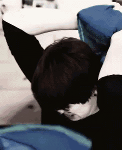 a person is laying on their back with their arms over their head