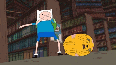 a cartoon character from adventure time is standing next to a yellow dog .