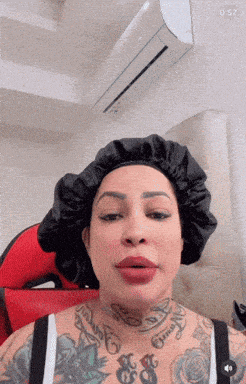 a woman with a tattoo on her neck is wearing a satin hat