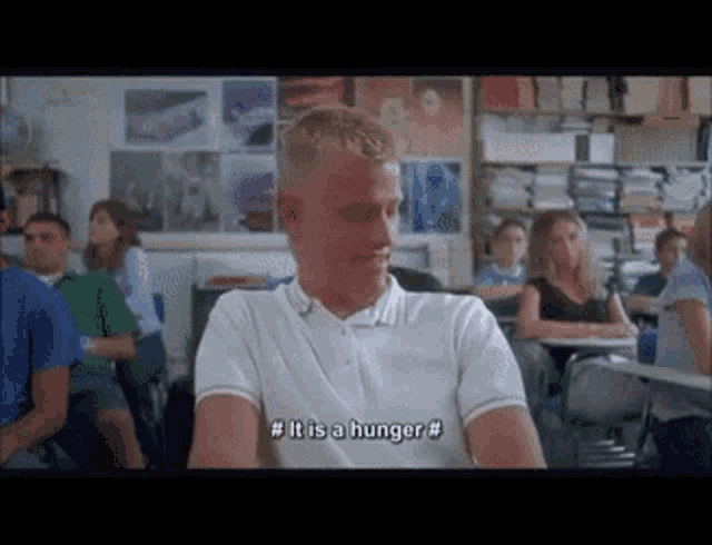 a man sitting in a classroom says it is a hunger