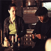 a man and a woman are sitting at a table with candles