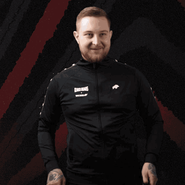 a man wearing a black jacket that says lizard kings on the front