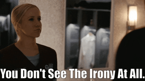 a woman stands in front of a mirror with the words " you don 't see the irony at all " below her