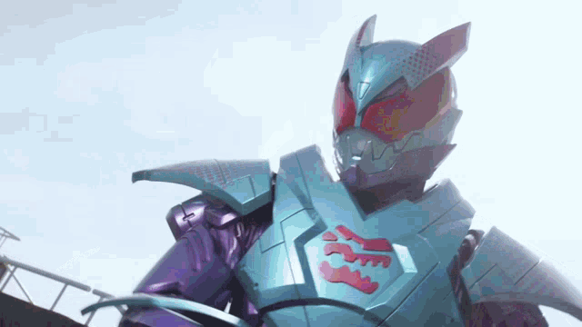 a close up of a purple and blue robot with a red logo on his chest .
