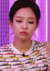a close up of a woman 's face with a purple background .
