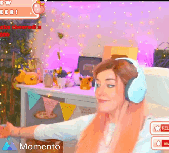 a woman wearing headphones is sitting in front of a screen that says momento on it