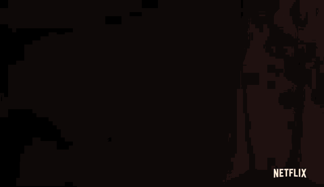 a close up of a person 's face with a netflix logo on the bottom right .