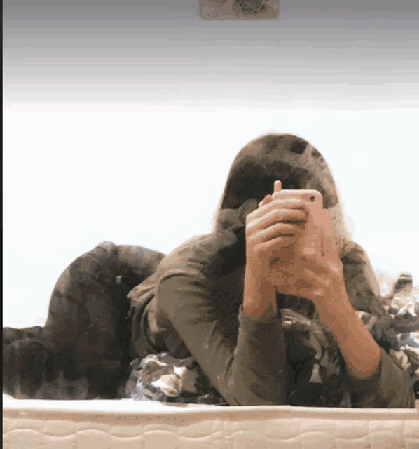 a woman taking a picture of herself in the mirror