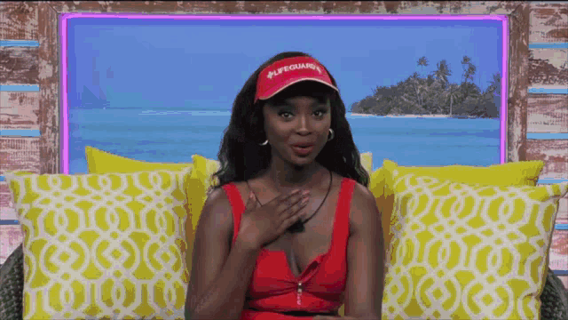 a woman in a lifeguard hat is sitting on a couch