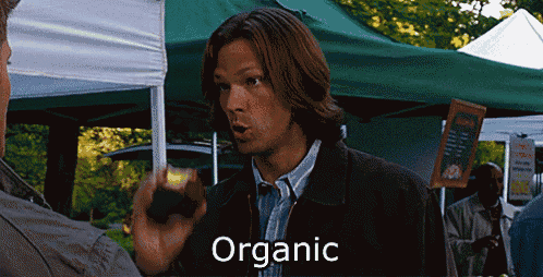 a man is talking to another man and the word organic is visible