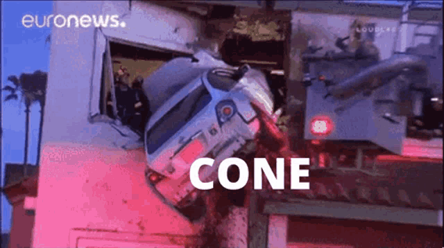 a car that has crashed into a building has the word cone on it