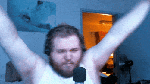 a man with a beard is wearing headphones and holding a microphone