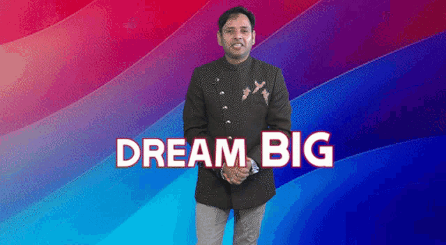a man in a suit stands in front of a colorful background with the words " dream big " on it