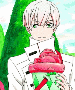 a boy with white hair and green eyes is holding a red and green item