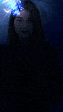a woman in a dark room with a blue butterfly on her face