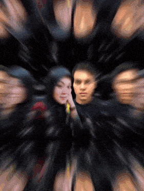 a blurry picture of a man and a woman in a black circle
