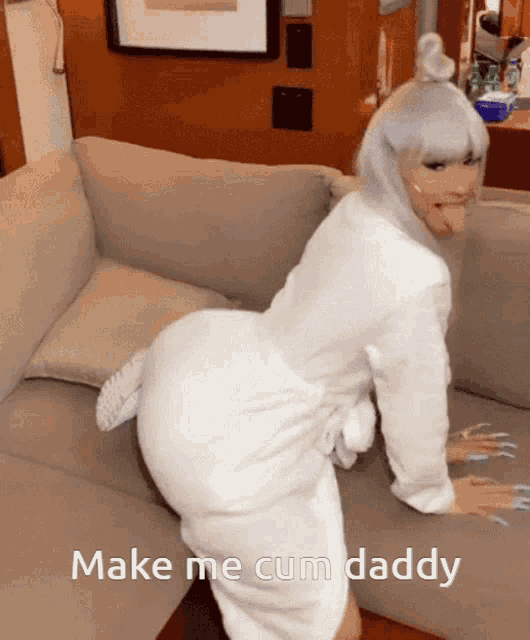 a woman in a white robe is kneeling on a couch with the words make me cum daddy written below her