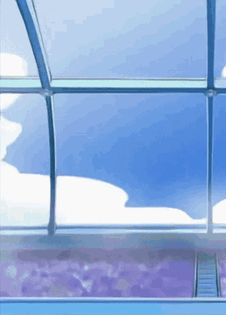 a blue sky is reflected in a glass window