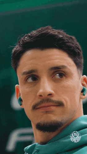 a close up of a man 's face with a palmeiras logo in the corner