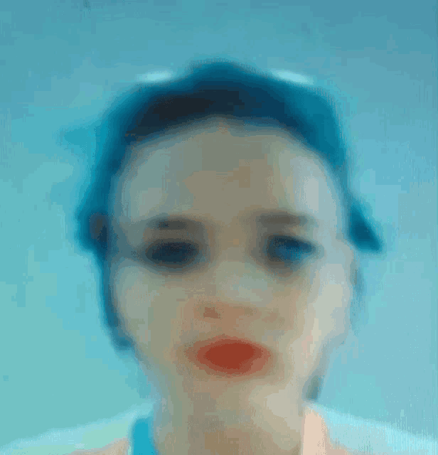 a blurry picture of a woman 's face with red lips
