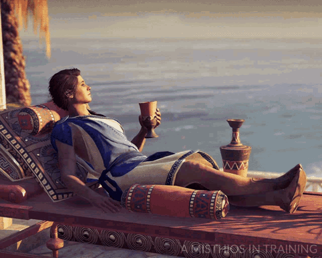 a woman laying on a lounge chair holding a cup with the words a mistikos in training below her