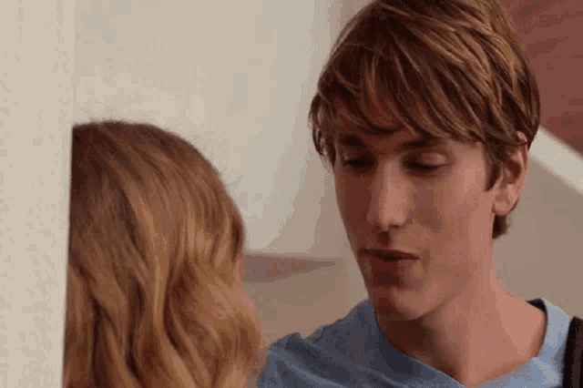 a man and a woman are looking at each other with their eyes closed