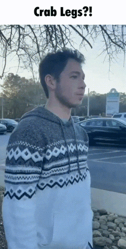 a man wearing a sweater with crab legs on it