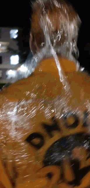 a close up of a person 's back with a yellow shirt that says ' o'neill ' on it
