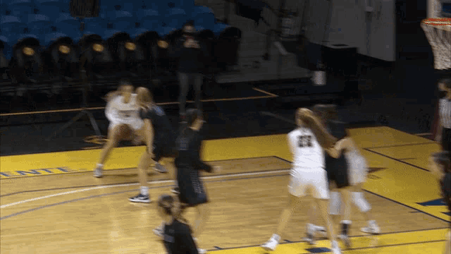 a basketball game is being played on a court with the word entl on it