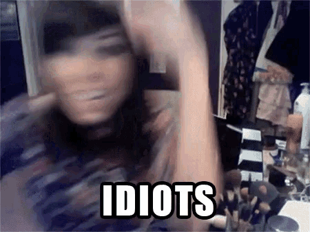 a blurry picture of a woman with the words idiots written on it