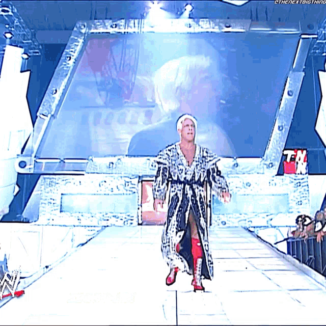 a man in a robe is walking down a ramp with the next thing written on the bottom