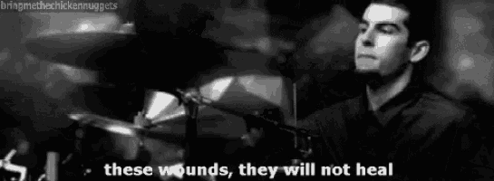 a black and white photo of a man playing drums with the words `` these wounds , they will not heal ''