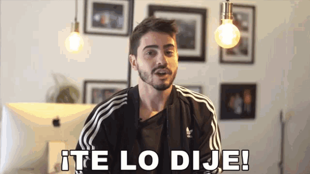 a man wearing a black adidas jacket says te lo dije