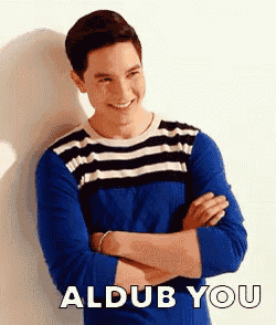 a man in a blue striped shirt is smiling with his arms crossed and the words aldub you behind him