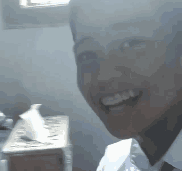 a close up of a person 's face with a tissue box in the background .