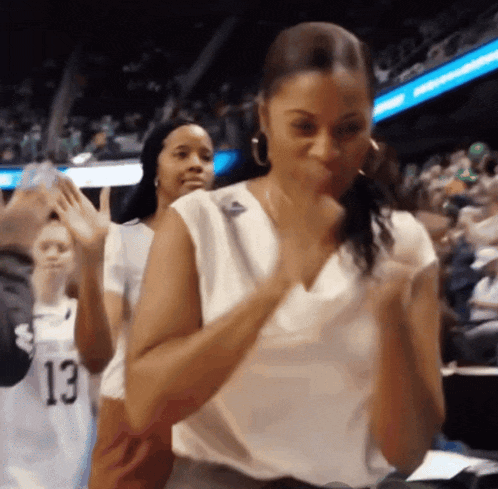 a woman in a white shirt with the number 13 on the back