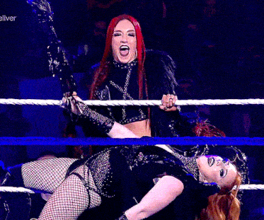 two women are wrestling in a ring with a sign in the background that says eliver