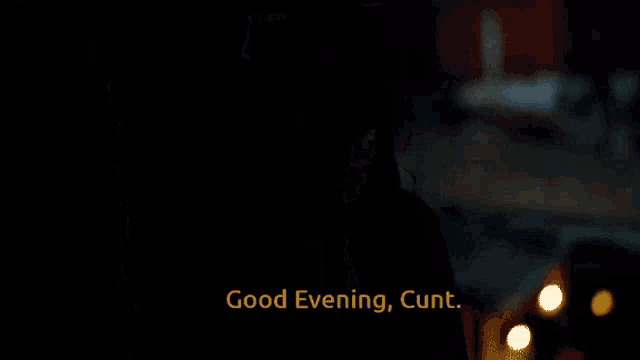 a woman in a hat says " good evening cunt " in a dark room