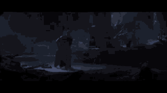 a monster is coming out of the water in a dark cave