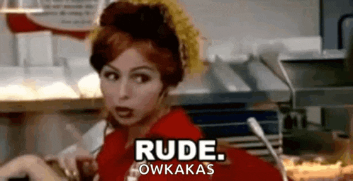 a woman in a red shirt is sitting at a counter in a restaurant and says `` rude . owkakas '' .
