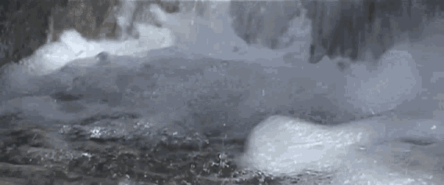 a close up of a waterfall with a lot of water coming out of it .